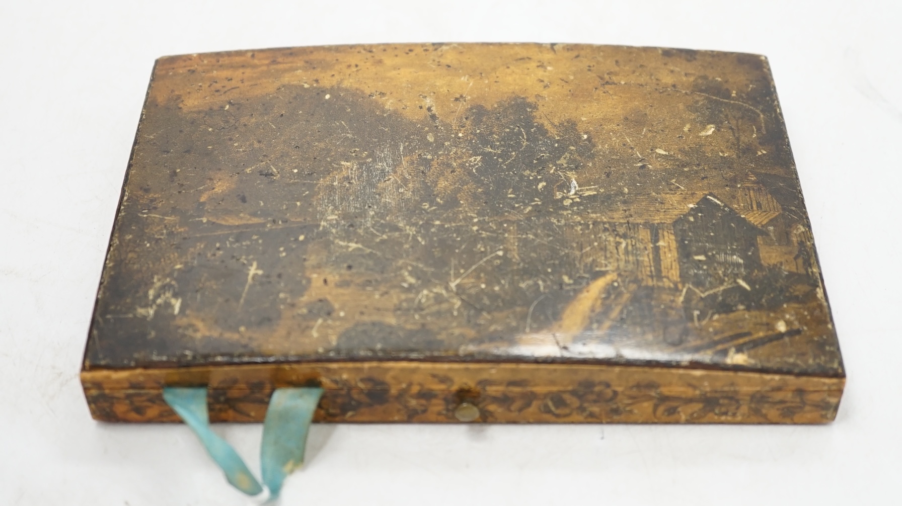 An early 19th century penwork box with country scene decoration to top cover and monkey and butterfly decoration to interior sectional cover, 17cm wide. Condition - box cover worn, interior of box fair